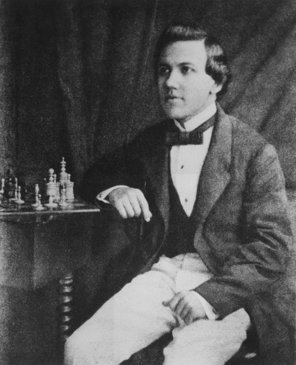 Paul Morphy sits with a set of Barleycorn pieces.