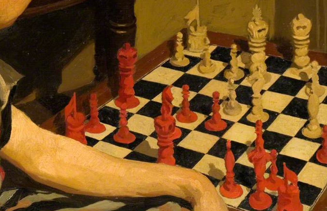 A red and white Burmese-Canton chess set, in mid-game, on a black and white board.