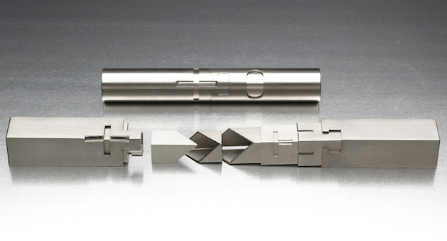 A tubular chess set. Above, pieces of rounded cross-section fully interlocking. Below, pieces of rectangular cross-section partially stacked to show how they fit together.